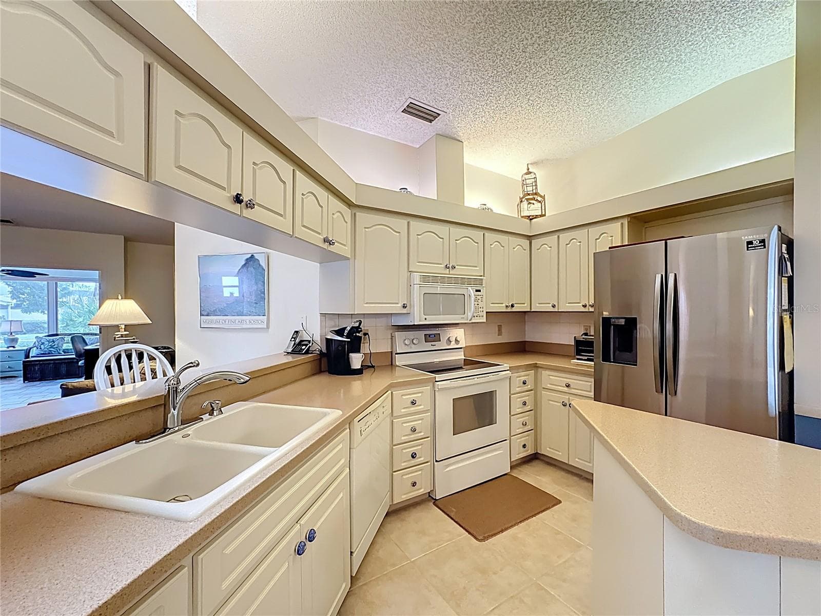 Corian counters and newer 2024 Samsung refrigerator. - 5611 GARDEN LAKES DR, BRADENTON