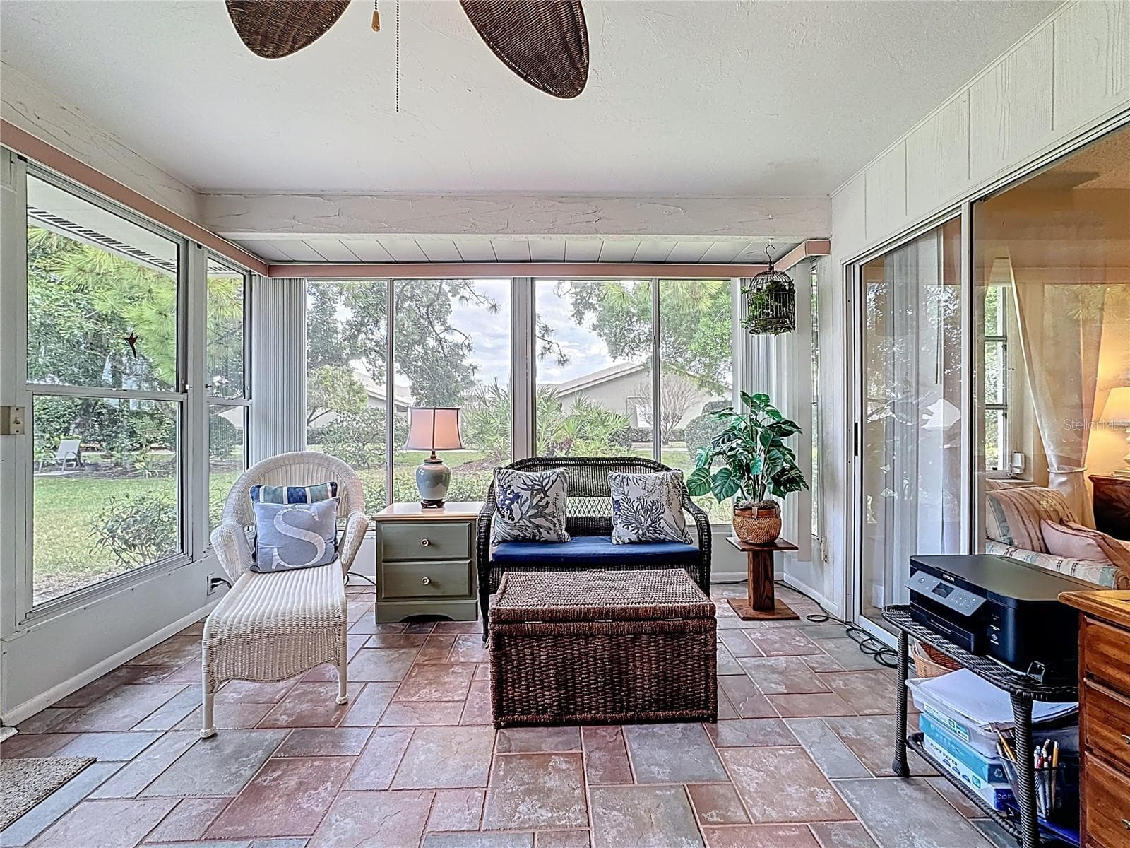 Air conditioned Florida room with primary suite to the right through the sliding doors. - 5611 GARDEN LAKES DR, BRADENTON