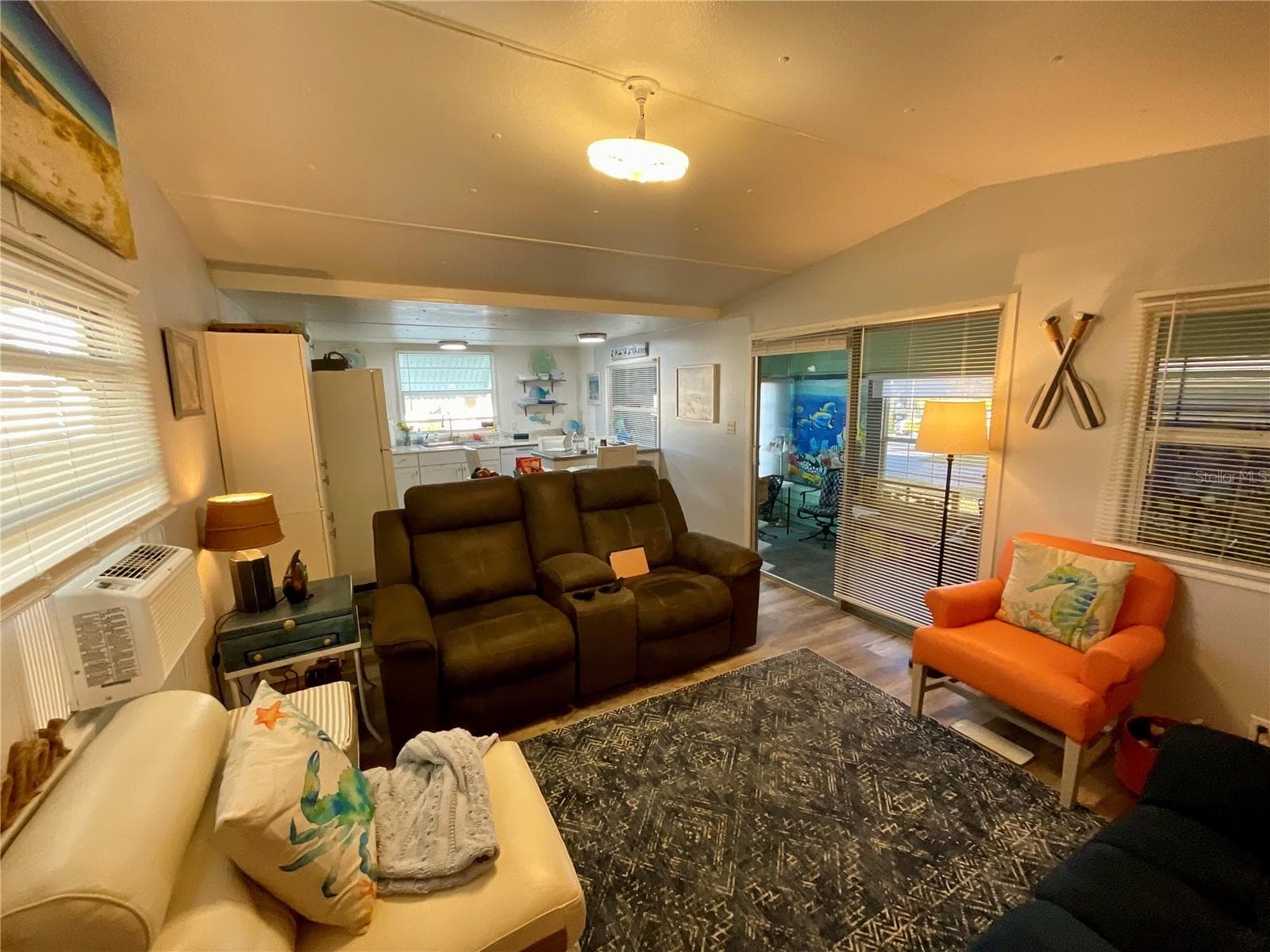 Open Living, Dining, and Kitchen floorplan. Flooded with light. Laminate flooring, neutral paint - 6580 SEMINOLE BLVD #510, SEMINOLE