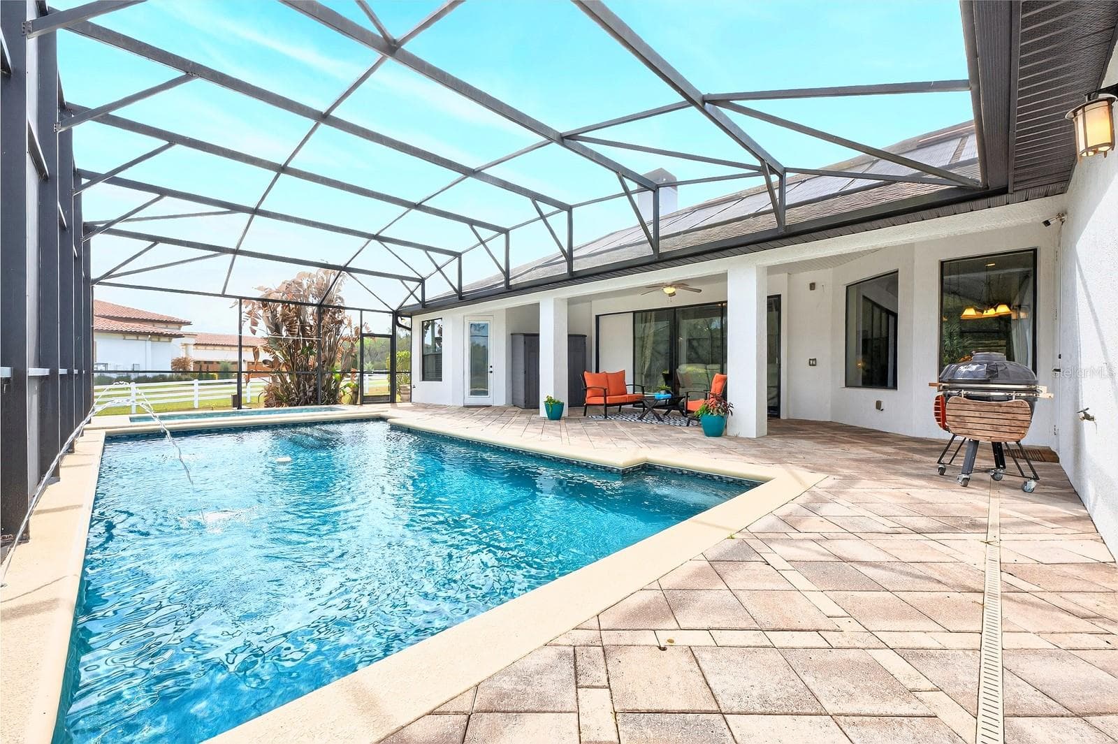 The COVERED LANAI and SCREENED POOL & SPA, creating the ultimate INDOOR/OUTDOOR Florida lifestyle! - 27324 GRAND OAK LN, TAVARES