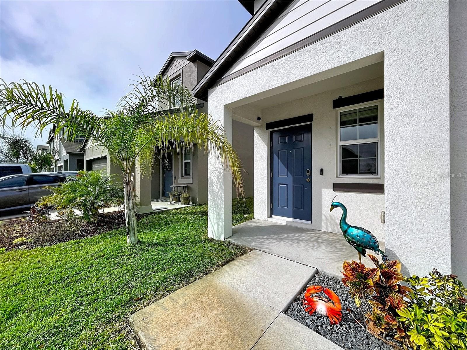 Front porch, home has hurricane shutters to cover the windows when needed! - 3141 OYSTER COVE ST, WIMAUMA
