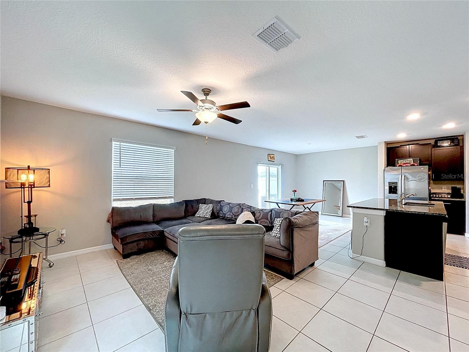Living room, large ceramic tiles flooring through the dining room as well. - 3141 OYSTER COVE ST, WIMAUMA