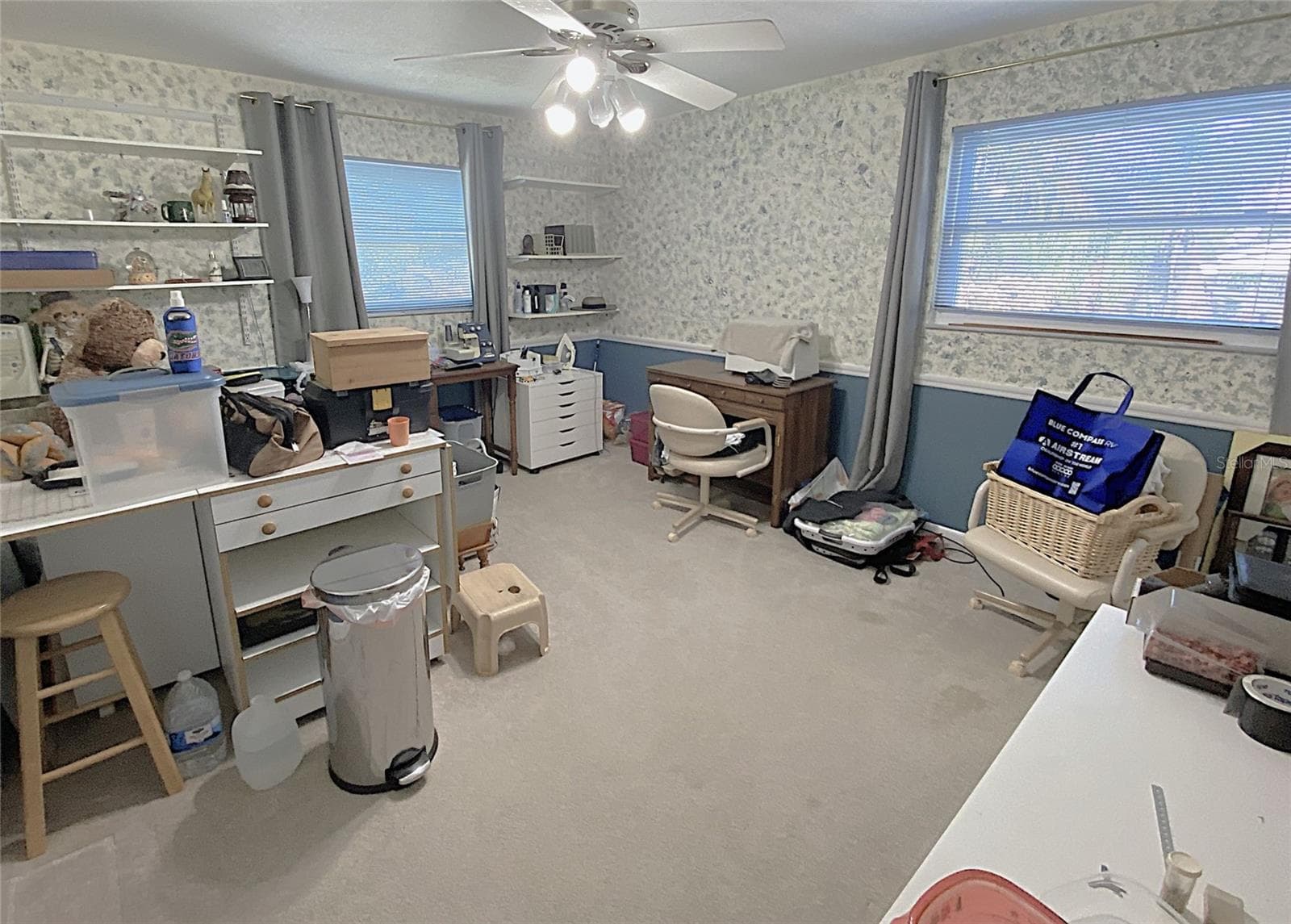 Bedroom 3 is currently being used as a craft room. It has carpet, a wall closet, shelves, ceiling fan and measures 12'x14' - 626 ORCHID LN, ALTAMONTE SPRINGS