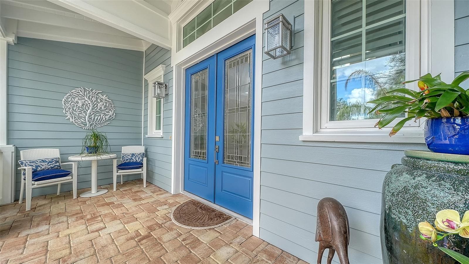 The front patio is large enough for a shaded seating area looking out over the front garden - 1794 CUNLIFF LN, SARASOTA