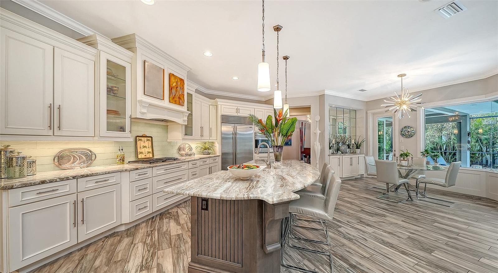 A large kitchen island, high end appliances and cabinetry are features of the kitchen, a Chef's delight! - 1794 CUNLIFF LN, SARASOTA