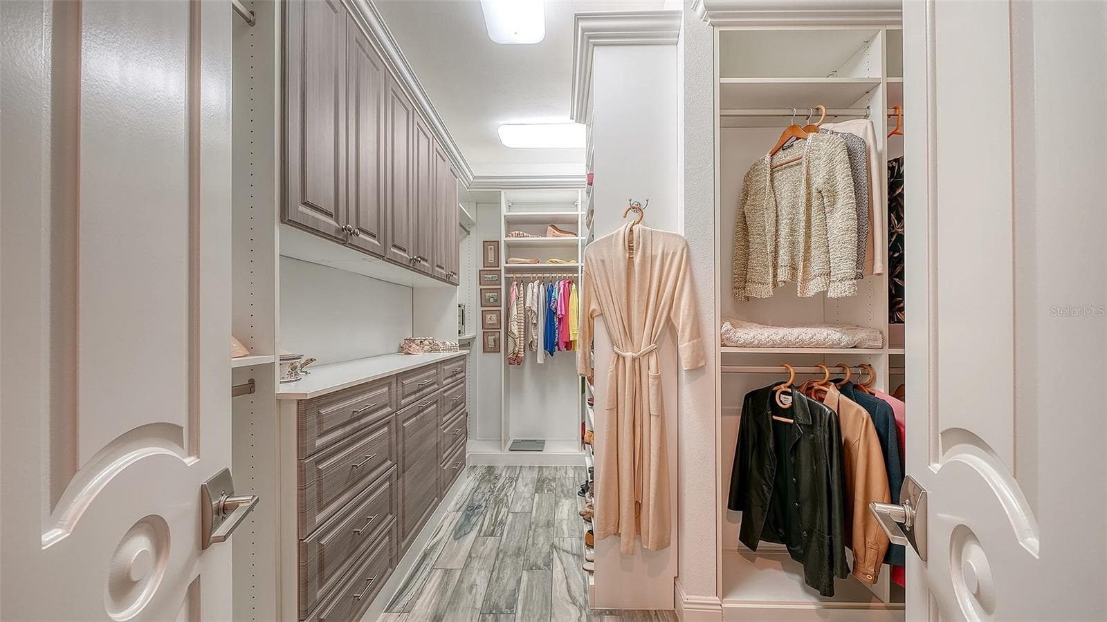 The large walk-in closet in the primary suite offers custom cabinetry and two separate areas for hanging clothes - 1794 CUNLIFF LN, SARASOTA