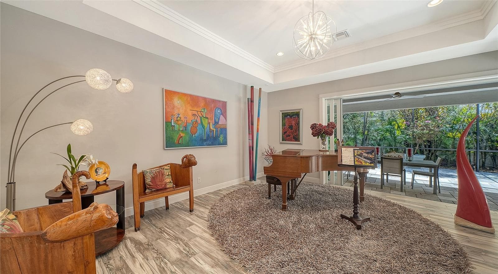 The bonus room features a disappearing wall of sliding glass doors looking out on the backyard oasis - 1794 CUNLIFF LN, SARASOTA