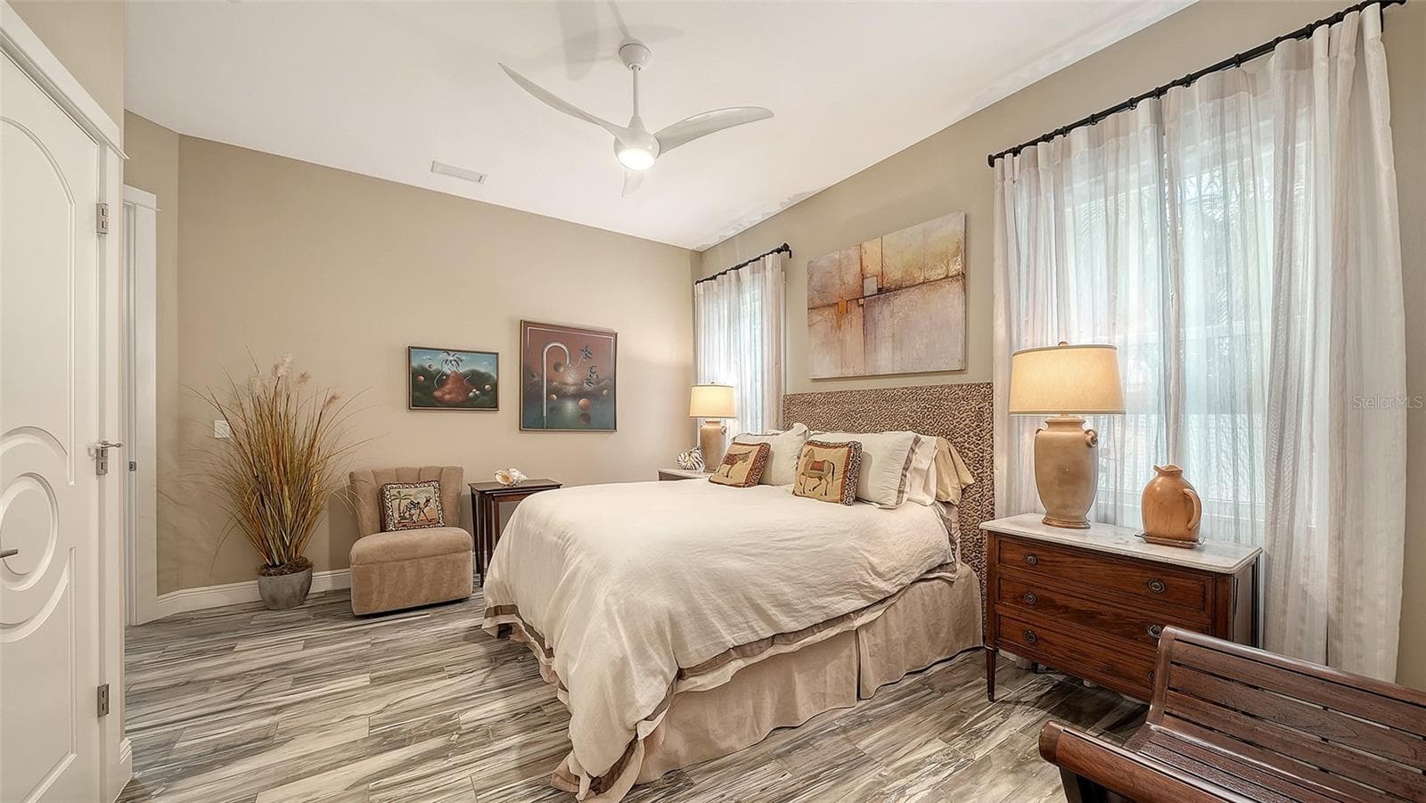 The second bedroom is located on the first floor, next to a hall bath, and features a walk-in closet with custom shelving - 1794 CUNLIFF LN, SARASOTA