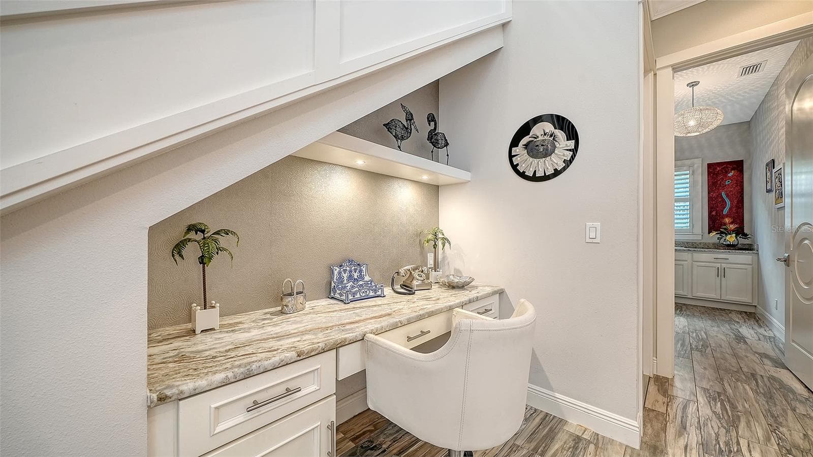 Tucked under the staircase is a handy built-in desk with granite countertop - 1794 CUNLIFF LN, SARASOTA