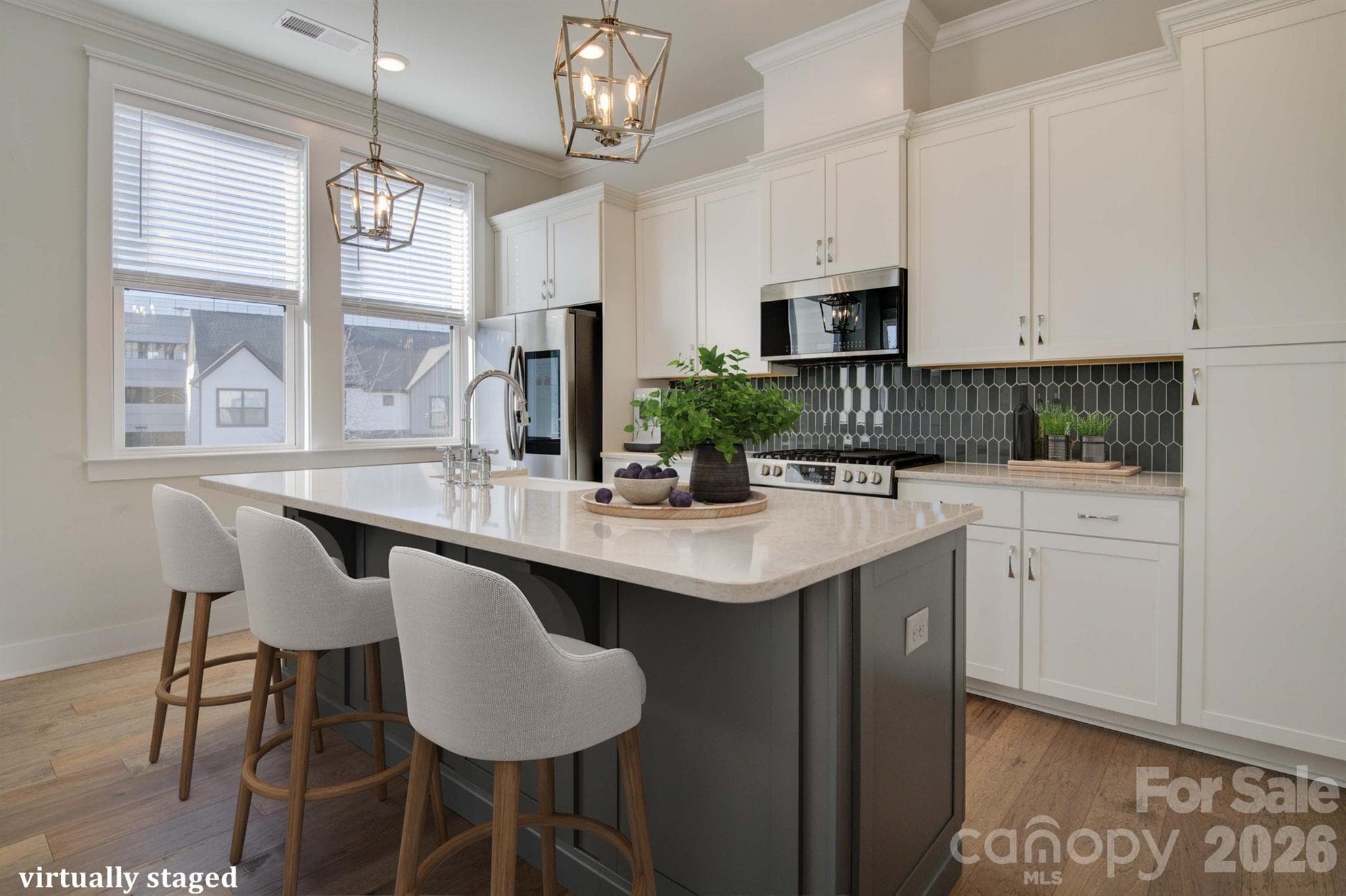 Virtually Staged open kitchen with spacious island, gas range, & plenty of cabinet storage - 5939 Ardrey Kell Road, Charlotte