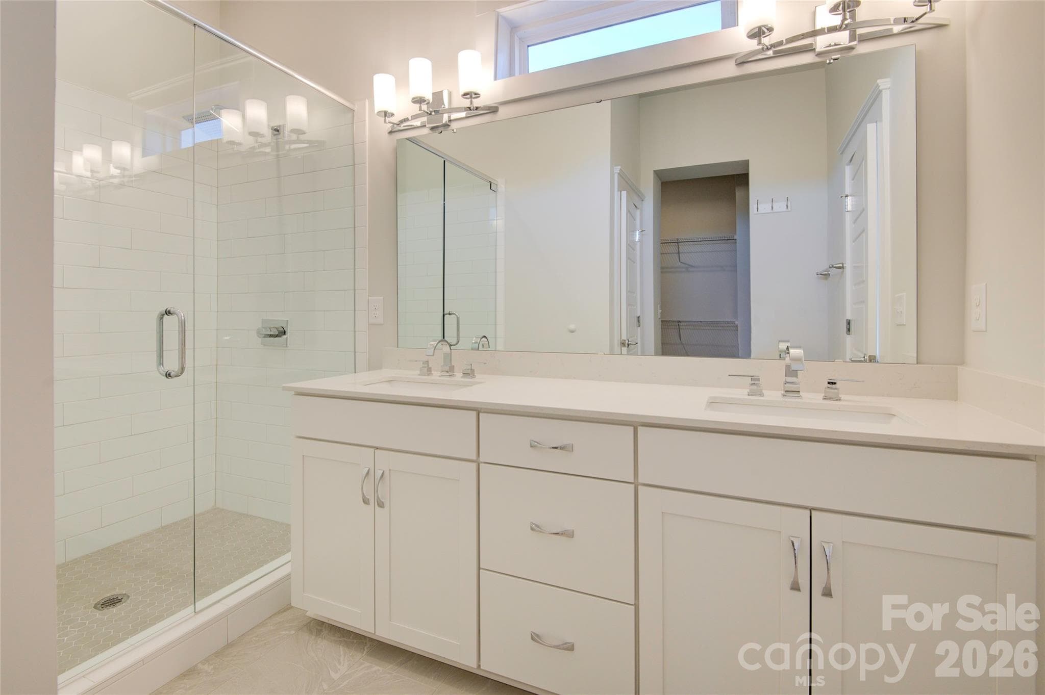 Primary bath with dual sinks, glass shower, large walk-in closet - 5939 Ardrey Kell Road, Charlotte