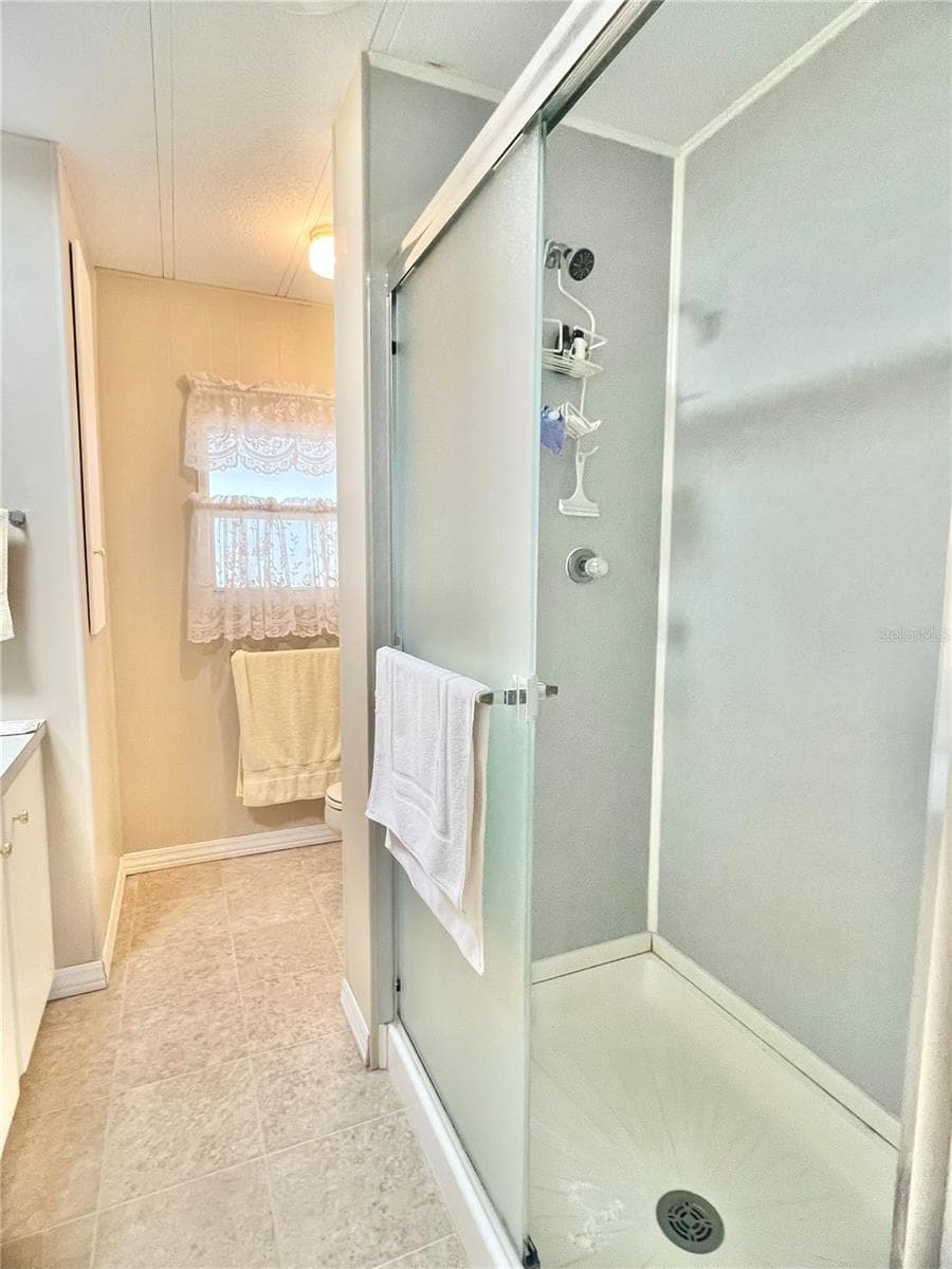 Hallway bathroom with walk in shower - 1100 BELCHER RD S #197, LARGO