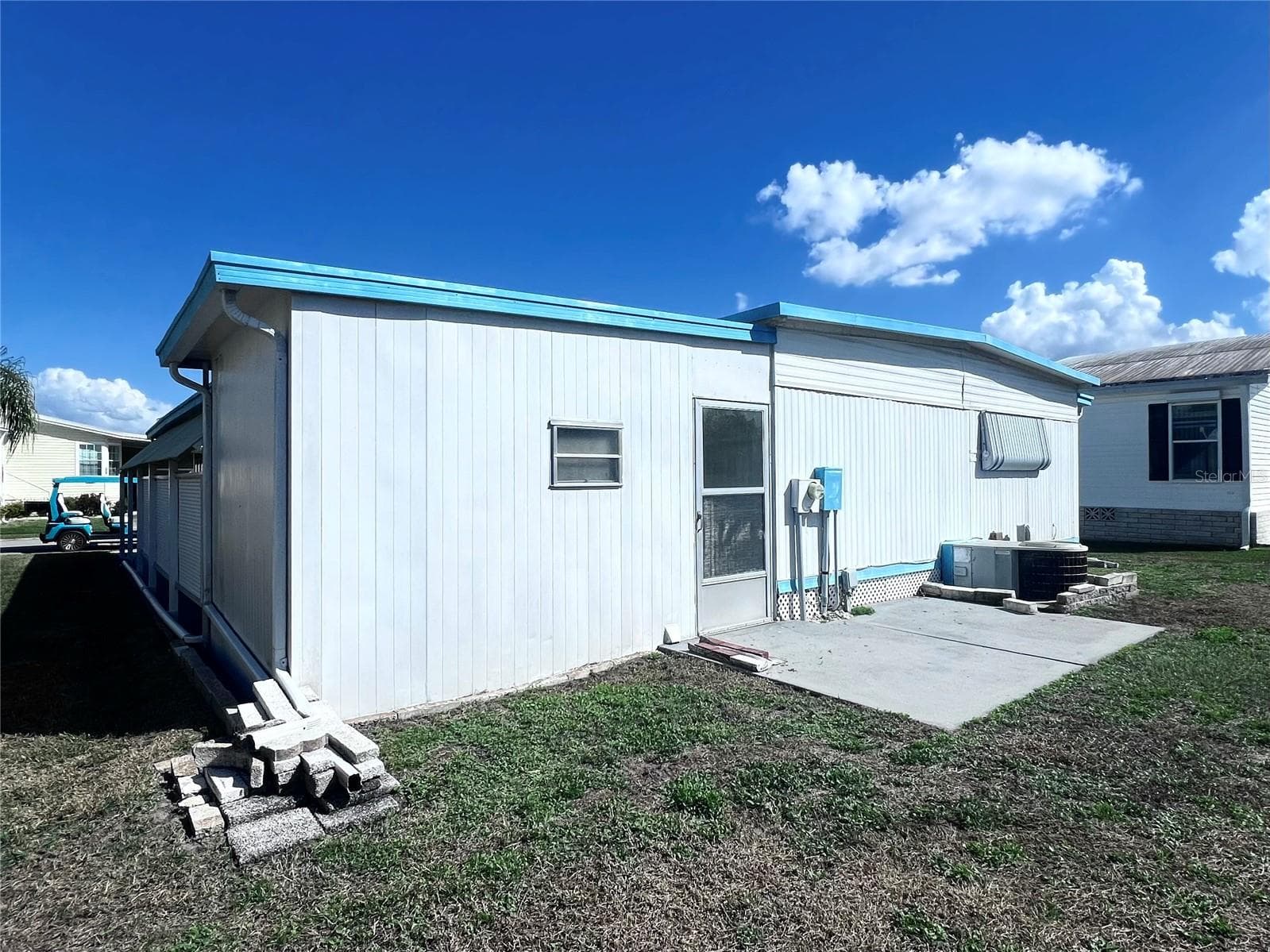 Back of home with patio - 1100 BELCHER RD S #197, LARGO
