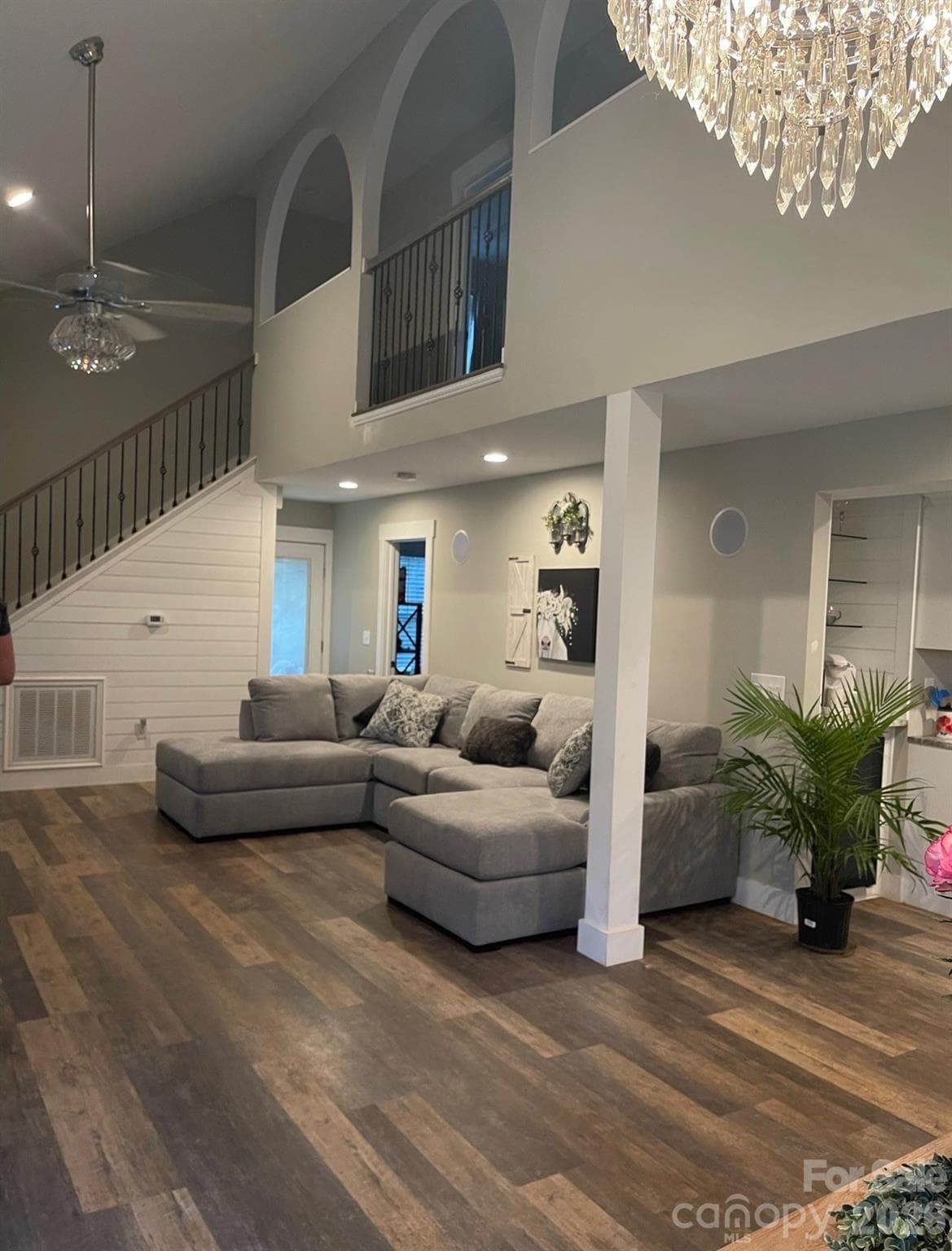 Vaulted Greatroom with beautiful elegant light fixtures and paddle fan. Arched openings match the opening in the kitchen to the rear foyer - 5111 Stockbridge Drive, Mount Holly