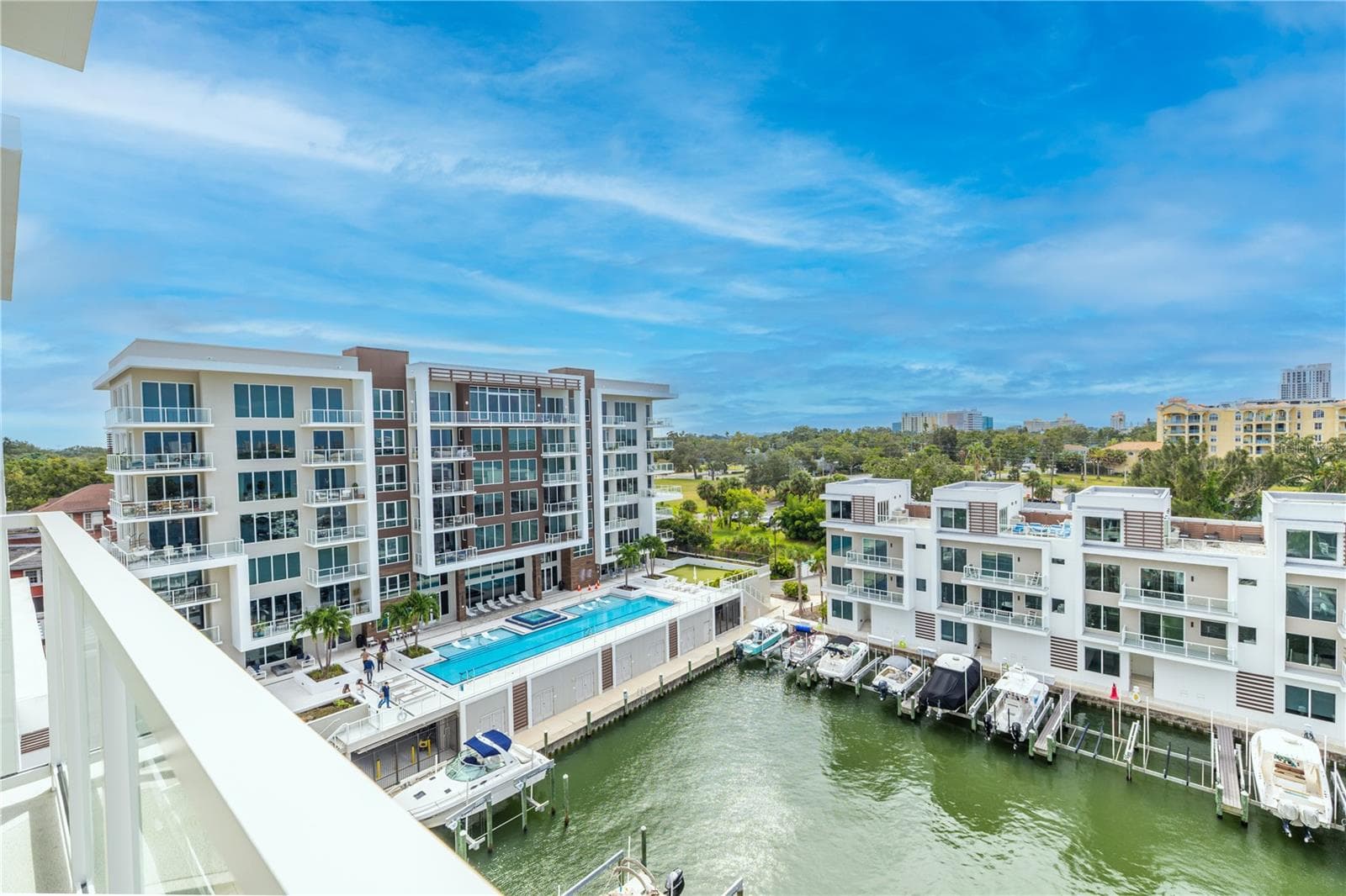 Look southeast for a view of the 25 meter lap pool with hot tub, outdoor fire table, BBQ and dining areas, outdoor putting green, and the full service marina. - 920 N OSCEOLA AVE #703, CLEARWATER