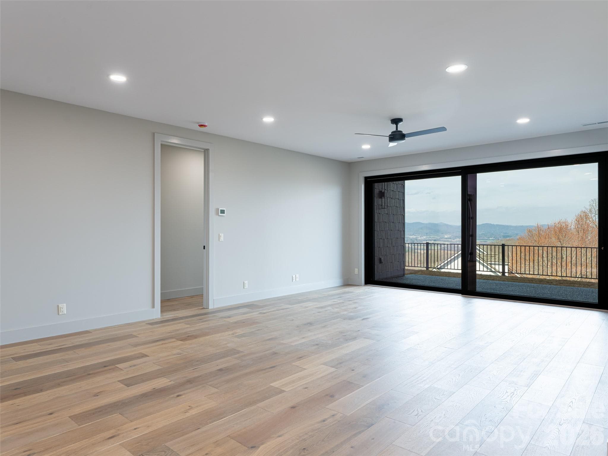 Family Room in Basement with sliding glass doors to terrace level patio - 247 Coachman Drive, Hendersonville