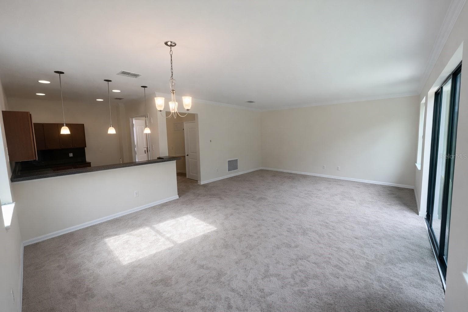 Great room with sliding glass doors to outdoors - 1187 CHERVIL DR, POINCIANA