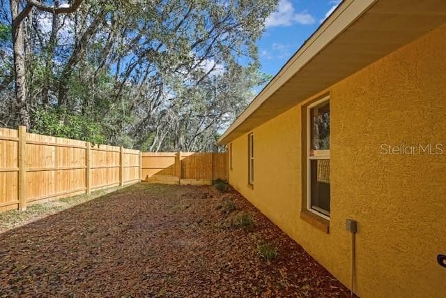 Fenced area side of home - 340 E SAVOY ST, LECANTO