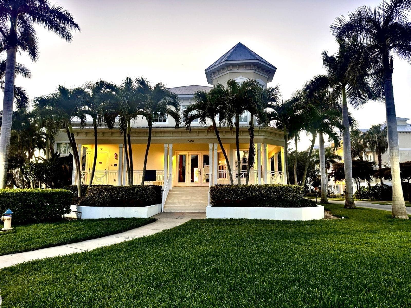 Community clubhouse entrance at dusk - 3418 79TH STREET CIR W #101, BRADENTON