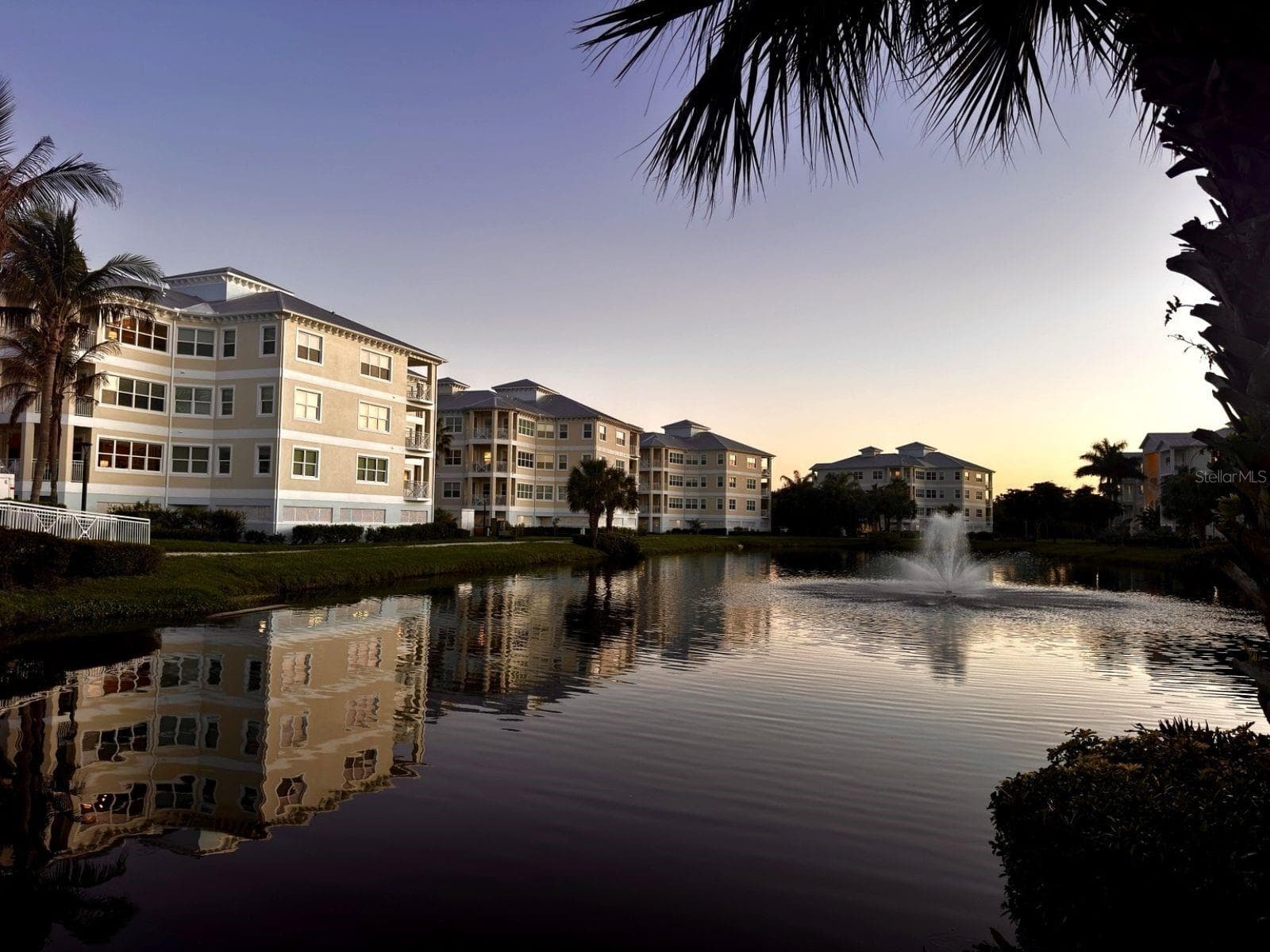 Lakefront buildings with fountain at sunset - 3418 79TH STREET CIR W #101, BRADENTON