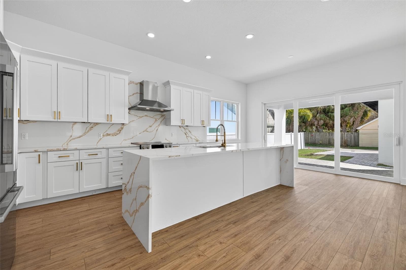 Generous kitchen with waterfall quartz countertop island. - 842 30TH AVE, ST PETERSBURG
