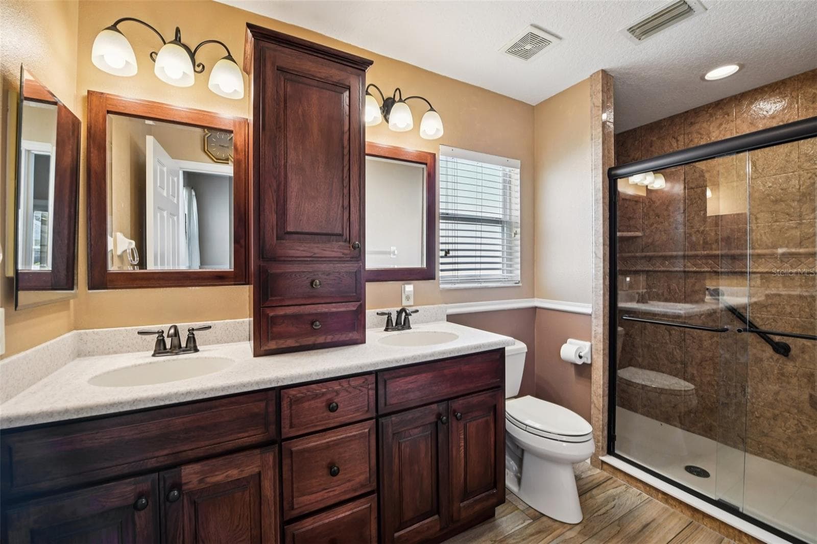 Bath Primary with wood cabinets, Corian countertops modern walk in shower. - 6105 DORY WAY, TAVARES