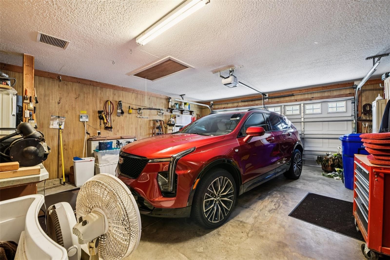Double garage with storage, work areas and Peg board all the way around. - 6105 DORY WAY, TAVARES