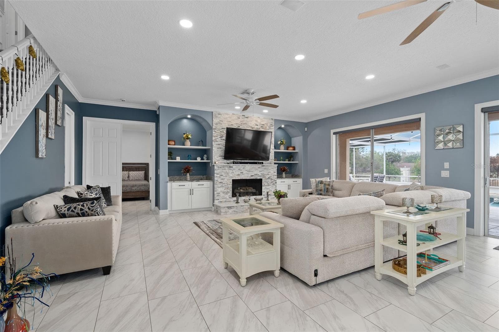 Family Room with custom stone fireplace, tile throughout the main floor, this whole home has been completely remodeled to perfection. - 9057 BALMORAL MEWS SQ, WINDERMERE