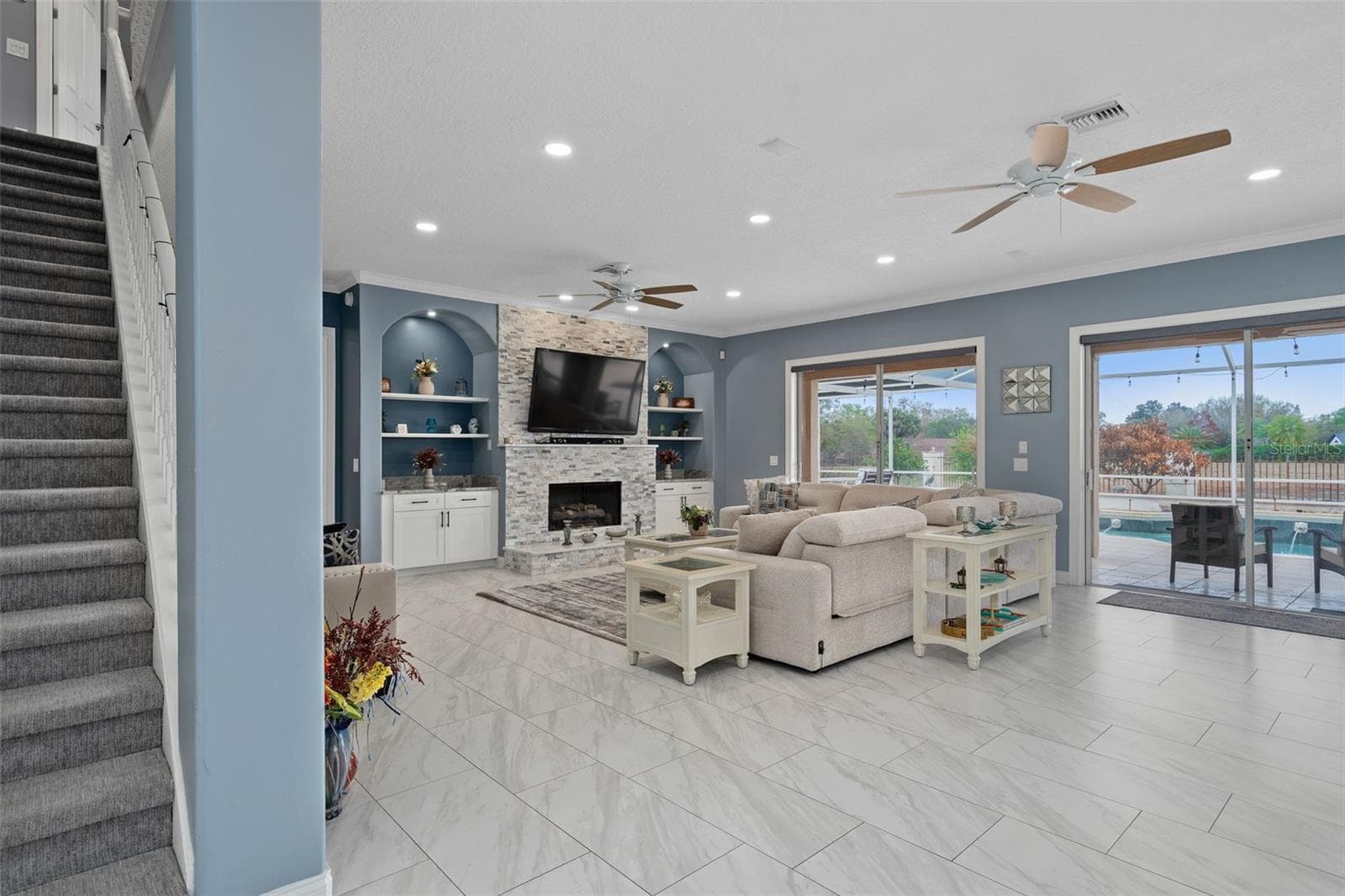Family Room with custom drawers built into the wall mirroring both sides of the fireplace. - 9057 BALMORAL MEWS SQ, WINDERMERE