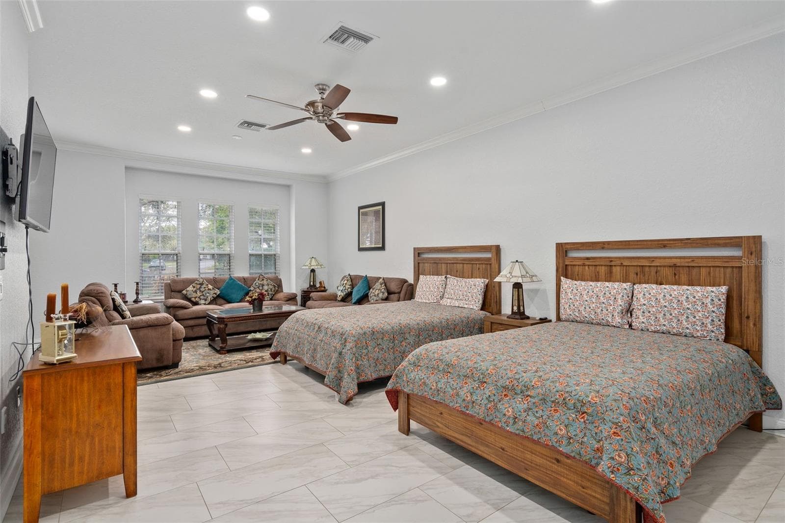 Downstairs Primary Bedroom with large sitting area. Has a door leading outside so could be used as an in law suite as well. - 9057 BALMORAL MEWS SQ, WINDERMERE