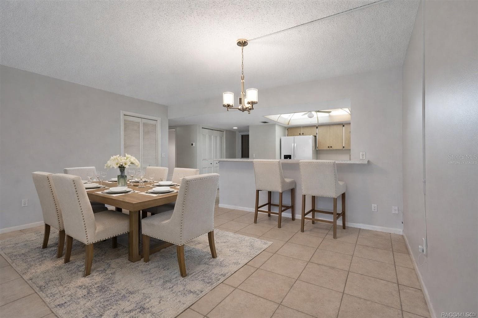 Virtually staged dining room showing breakfast bar with stools - 3 CYPRESS RUN #35A, HOMOSASSA