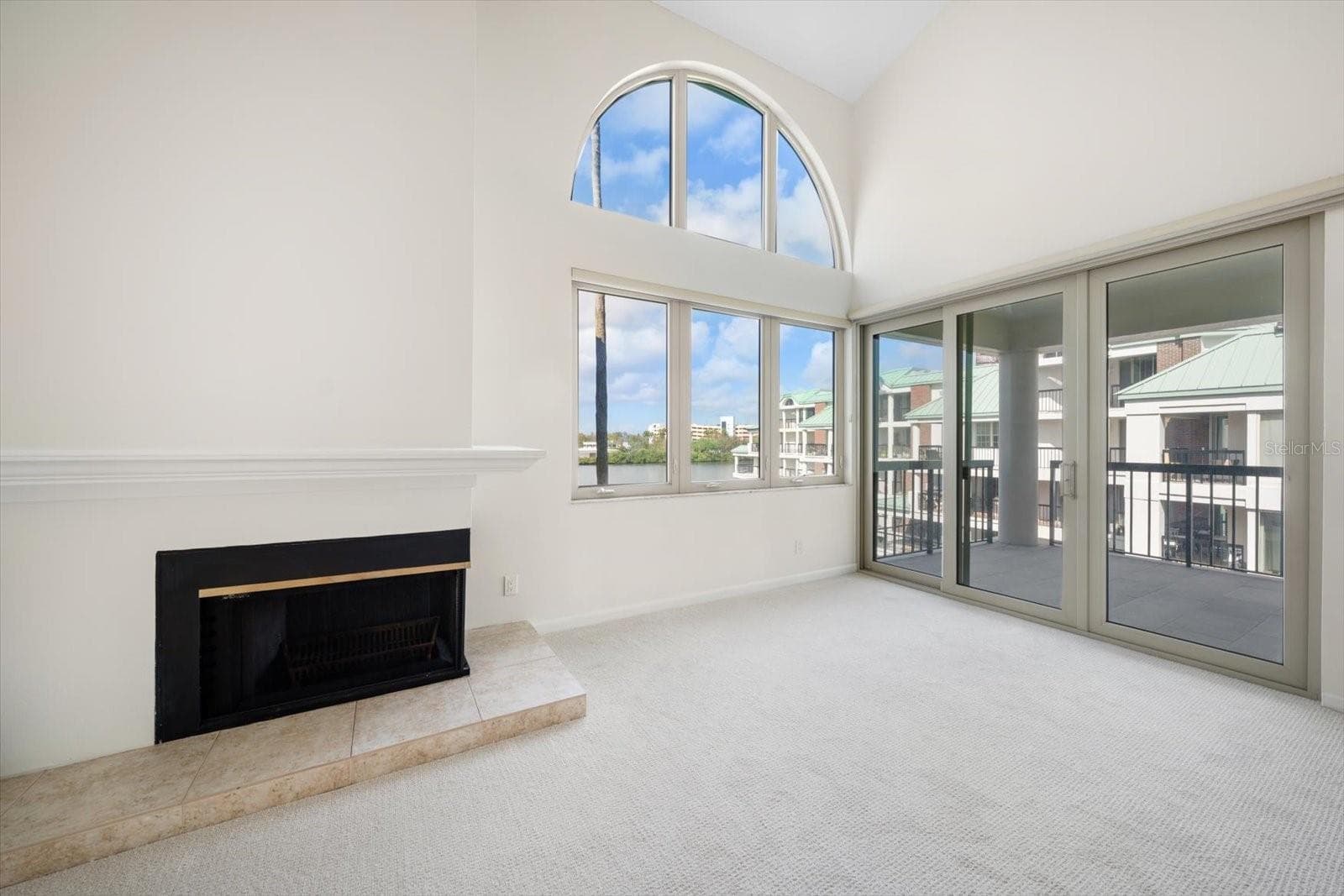 Living room opens to a large balcony, both with water views - 947 SEDDON COVE WAY #947, TAMPA