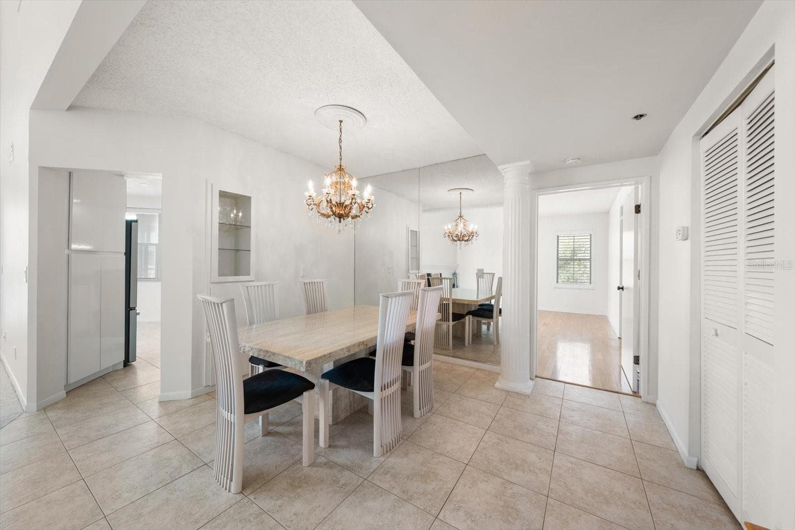 Formal dining room. Entry to kitchen on left, door to first-level primary suite on right. - 947 SEDDON COVE WAY #947, TAMPA