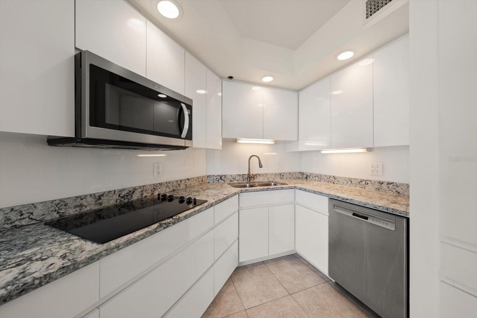 Kitchen with Cambria quartz counters, ample cabinet space and pantry cabinets to the right. - 947 SEDDON COVE WAY #947, TAMPA