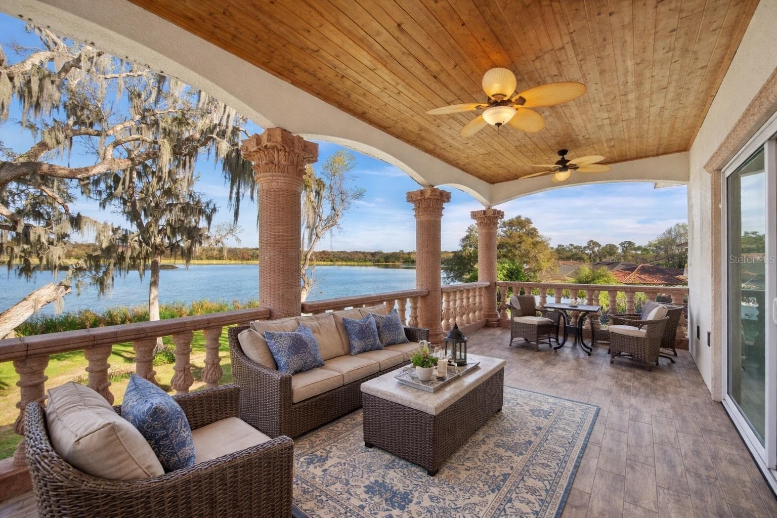 Upstairs rear balcony - Virtual staging added to demonstrate possible furniture placement. - 775 CHRISTINA LAKE DR, LAKELAND