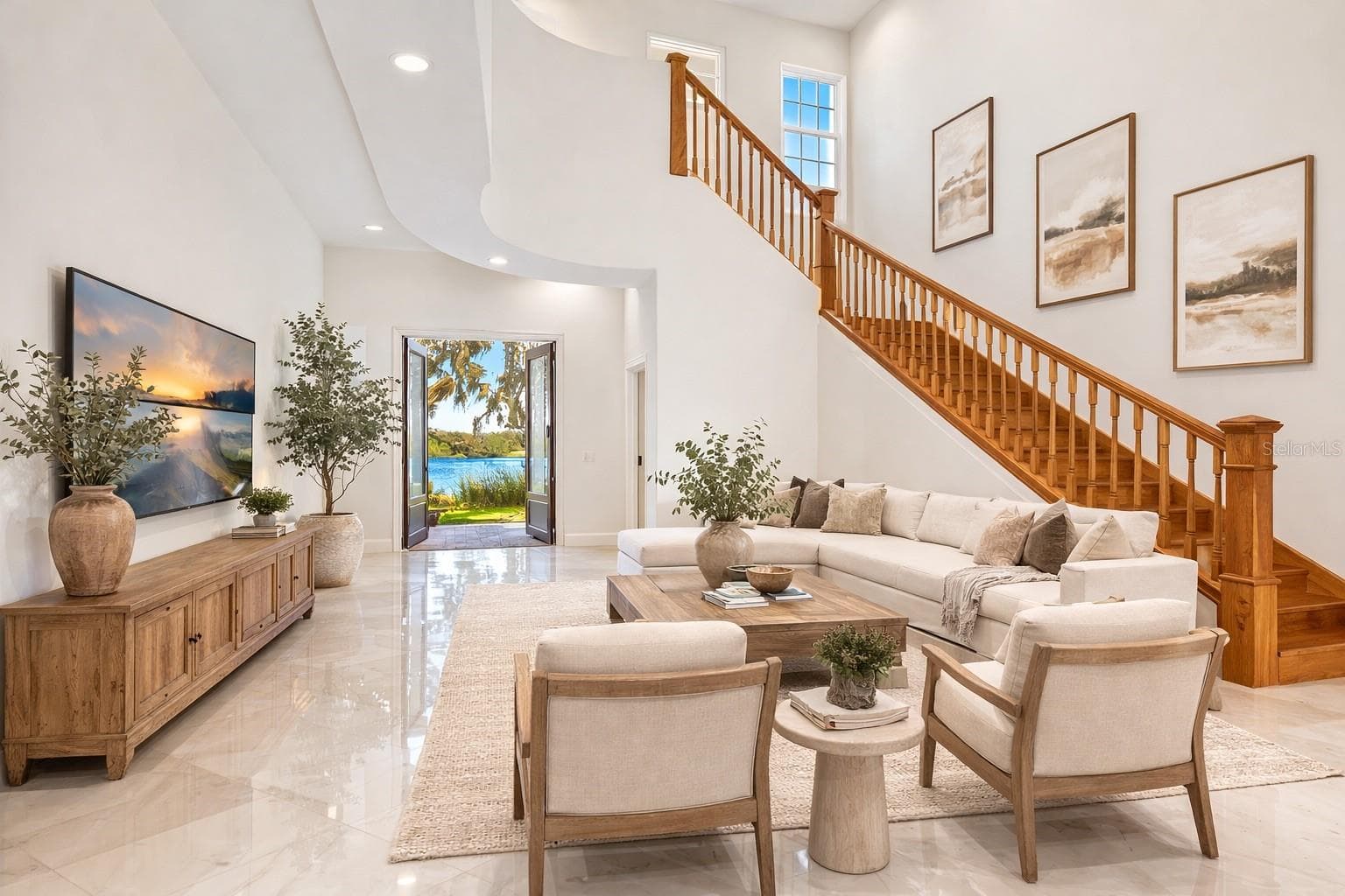 Living room, with view of lake - Virtual staging added to demonstrate possible furniture placement. - 775 CHRISTINA LAKE DR, LAKELAND