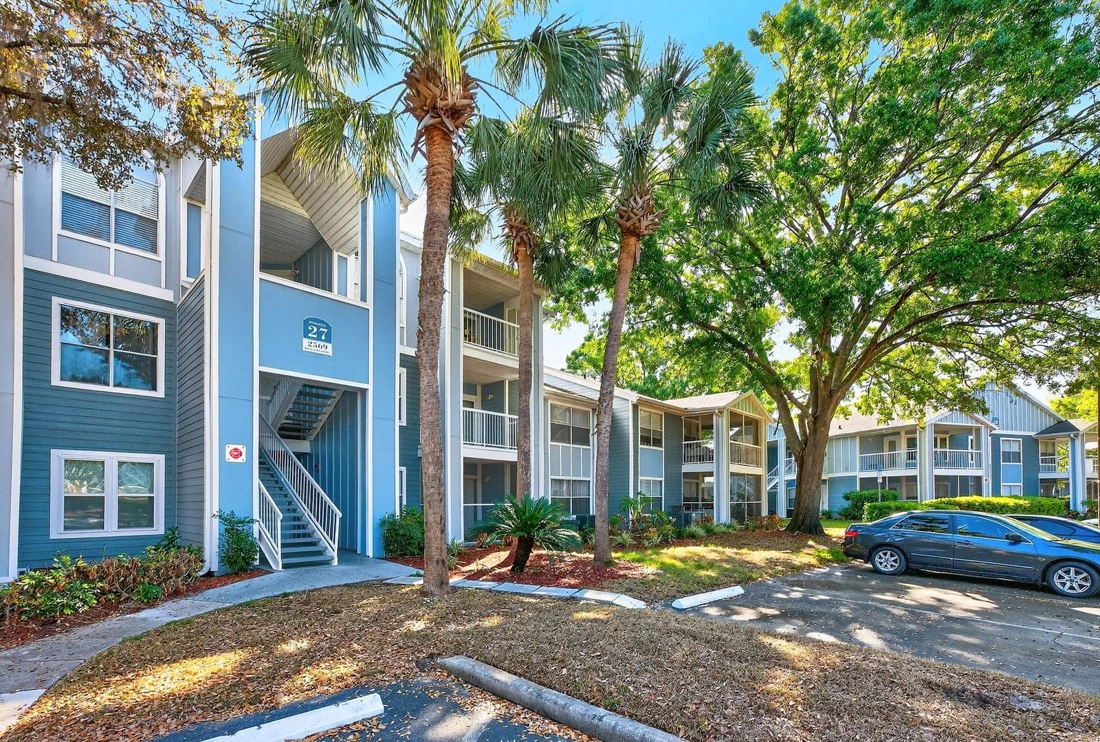 Mature trees create a park-like setting. - 2569 GRASSY POINT DR #207, LAKE MARY