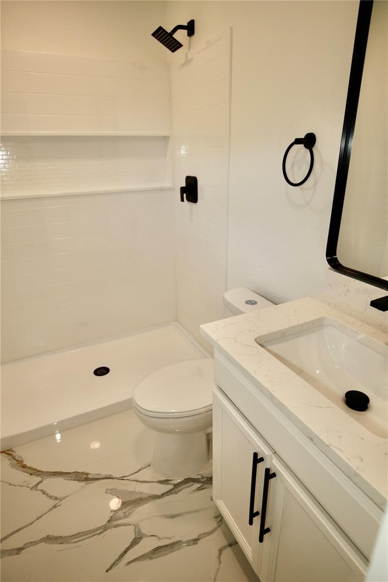 Primary Bathroom. Shower no tub. Porcelain floors and quartz counters. - 2235 WAUTOMA PL, ORLANDO