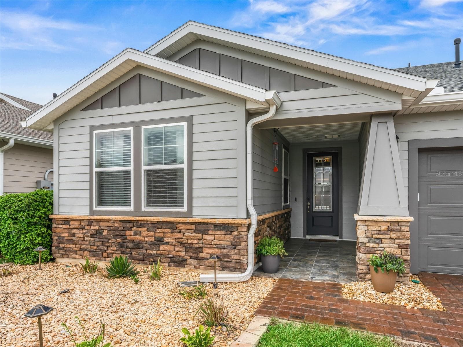 Gorgeous curb appeal with brick accents and front porch - 5662 NW 40TH LOOP, OCALA