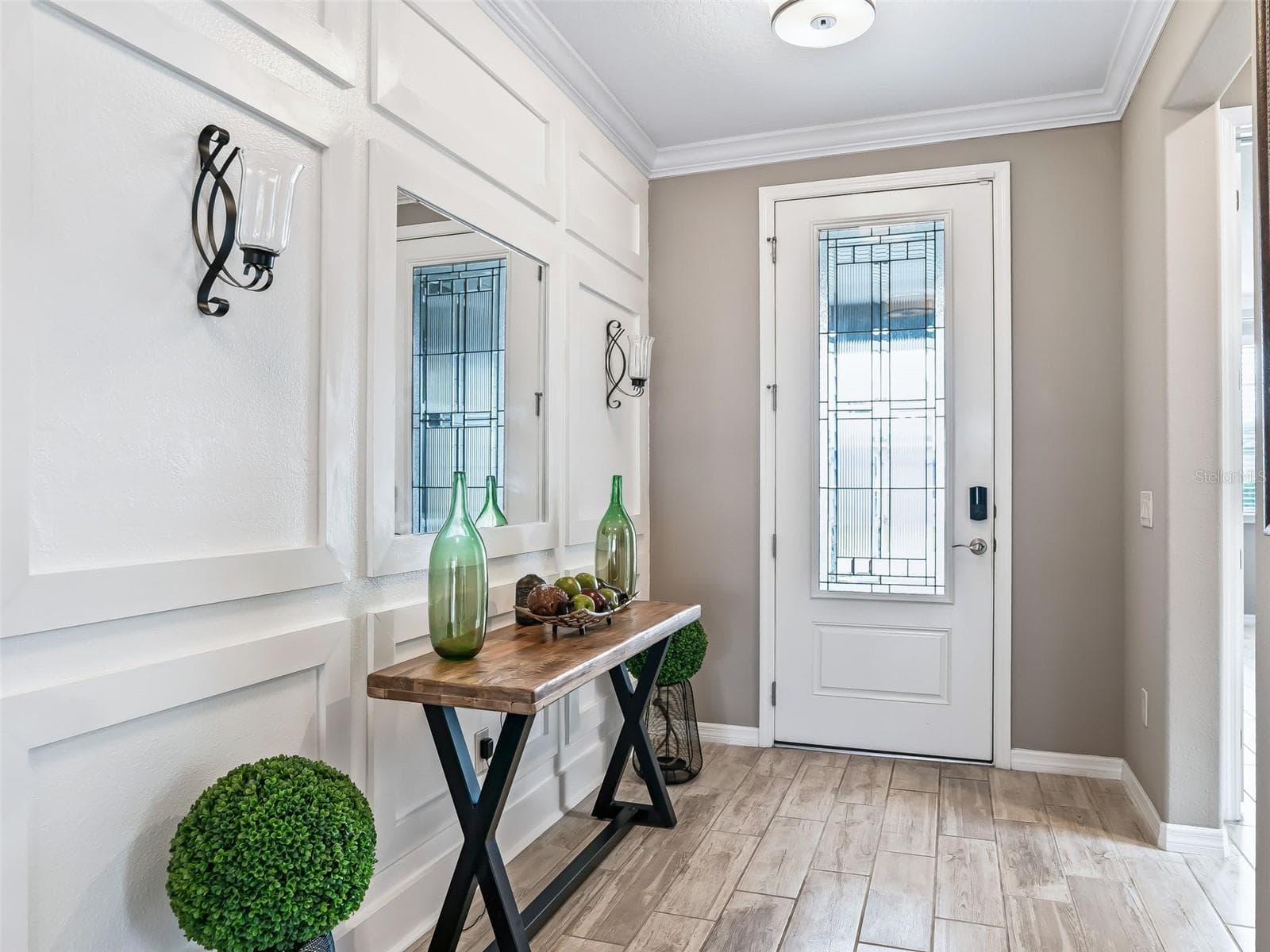 Elegant foyer with custom mirror and trim detail. Front door boasts an eight foot leaded glass front door - 5662 NW 40TH LOOP, OCALA