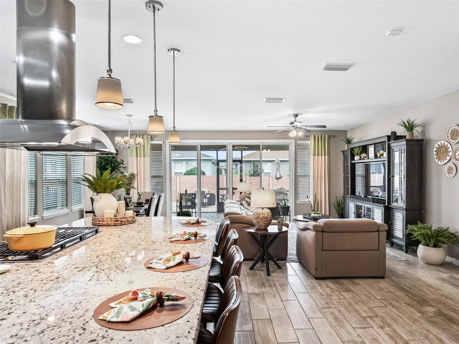 Gorgeous Kitchen with a large island, granite, gas cooktop and custom hood. Open layout and perfect for the entertainer at heart - 5662 NW 40TH LOOP, OCALA