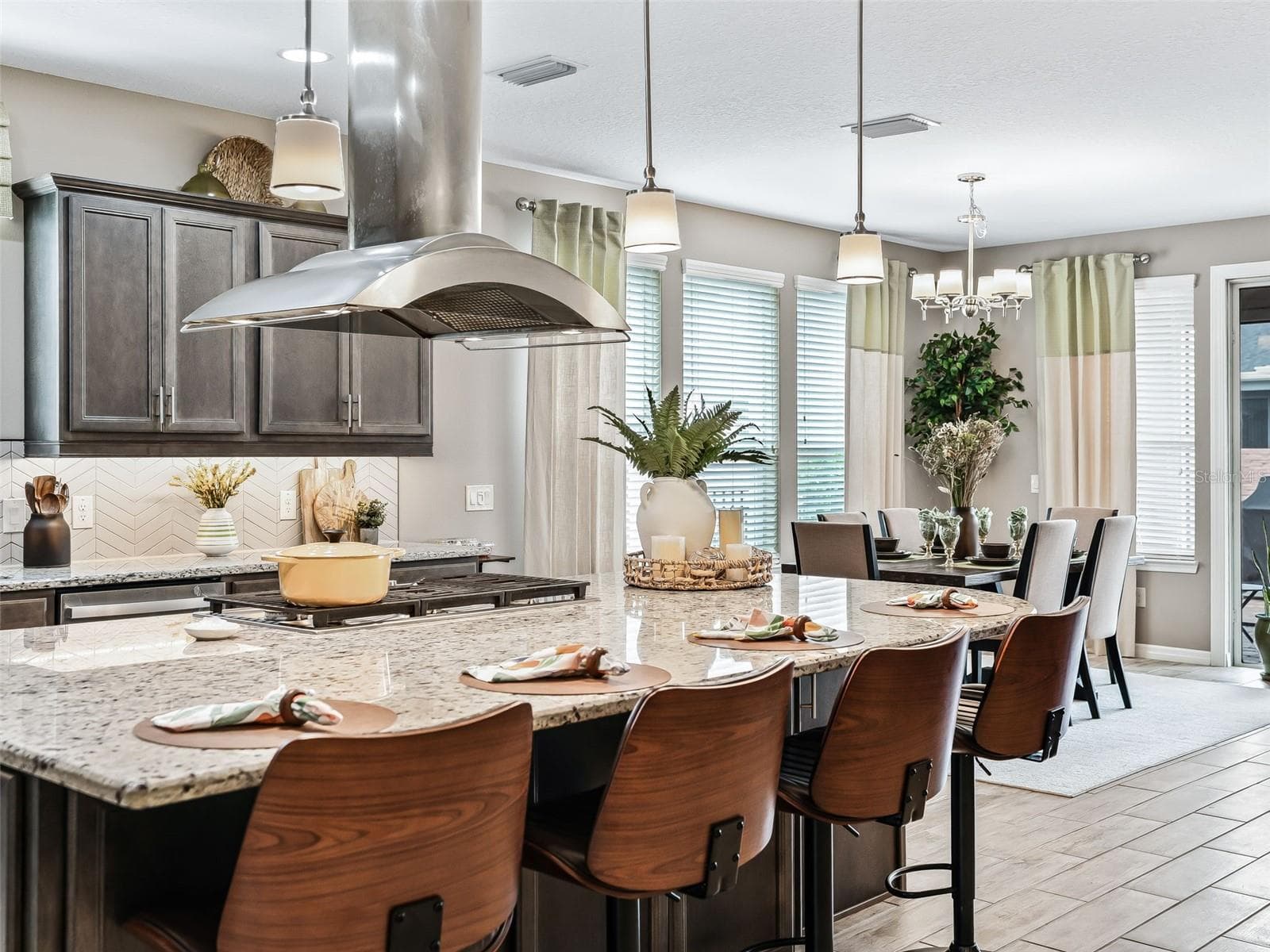Kitchen island with Five burner gas cooktop and chimney hood - 5662 NW 40TH LOOP, OCALA