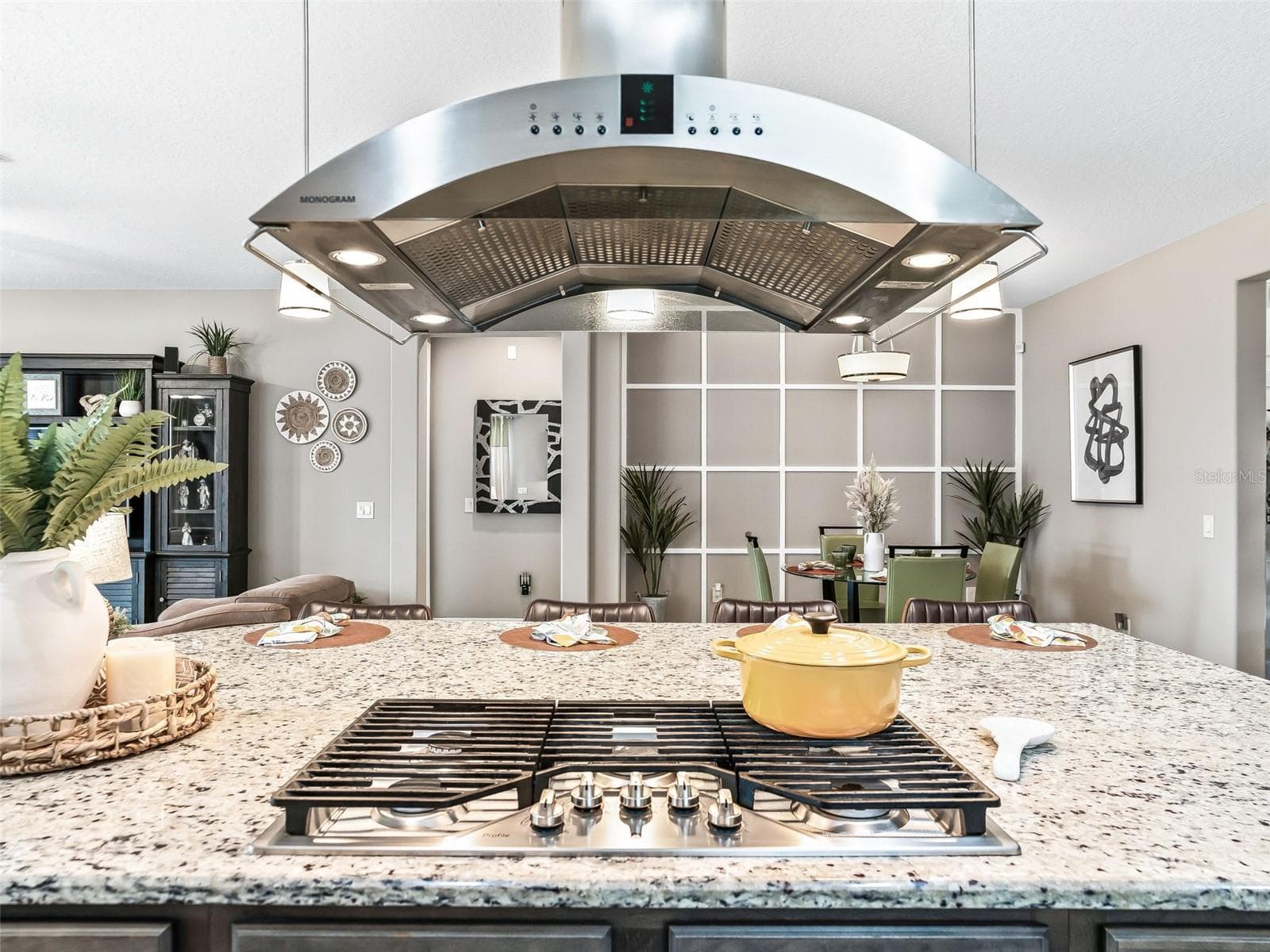 Gourmet kitchen presents the GE Profile 36" gas cooktop, chimney hood with plenty of natural lighting and designer lighting - 5662 NW 40TH LOOP, OCALA