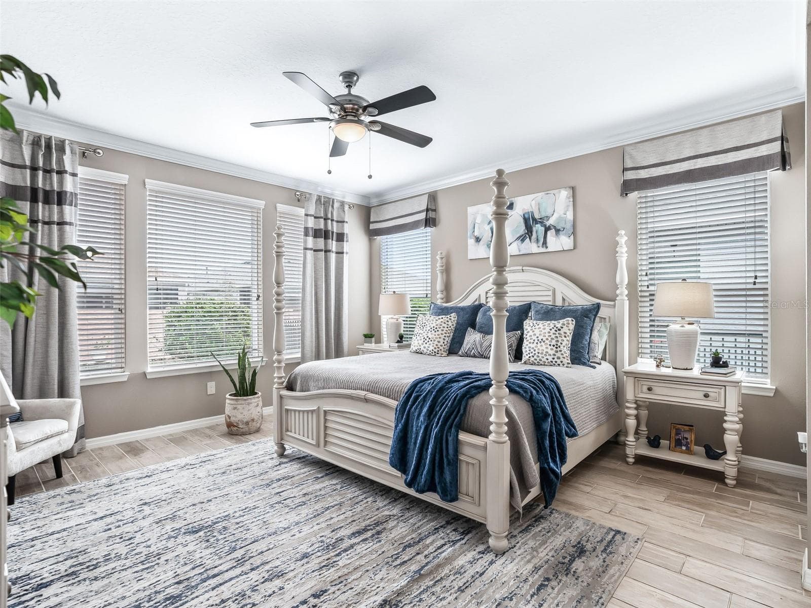 Primary suite with large picture windows, ceiling fan - 5662 NW 40TH LOOP, OCALA