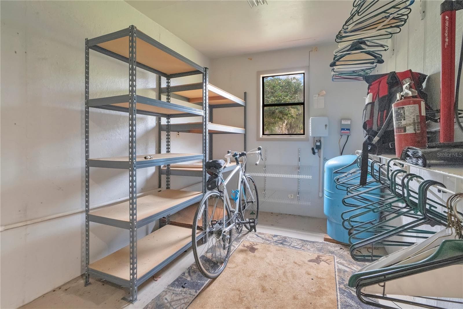 Storage area inside workshop/detached garage. Pressure tank for well is in here. - 1401 BUELL CT, PLANT CITY
