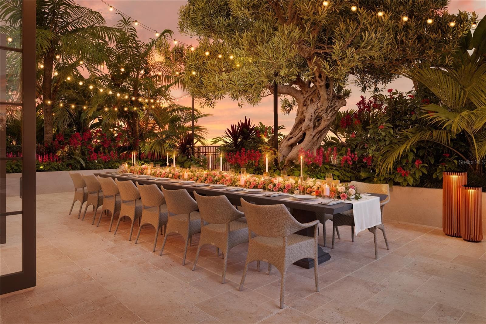 A beautifully landscaped garden terrace offers an intimate dining setting, where lush greenery and thoughtful design create a private oasis for residents to relax and entertain in style. - 65 S PALM AVE #1205, SARASOTA