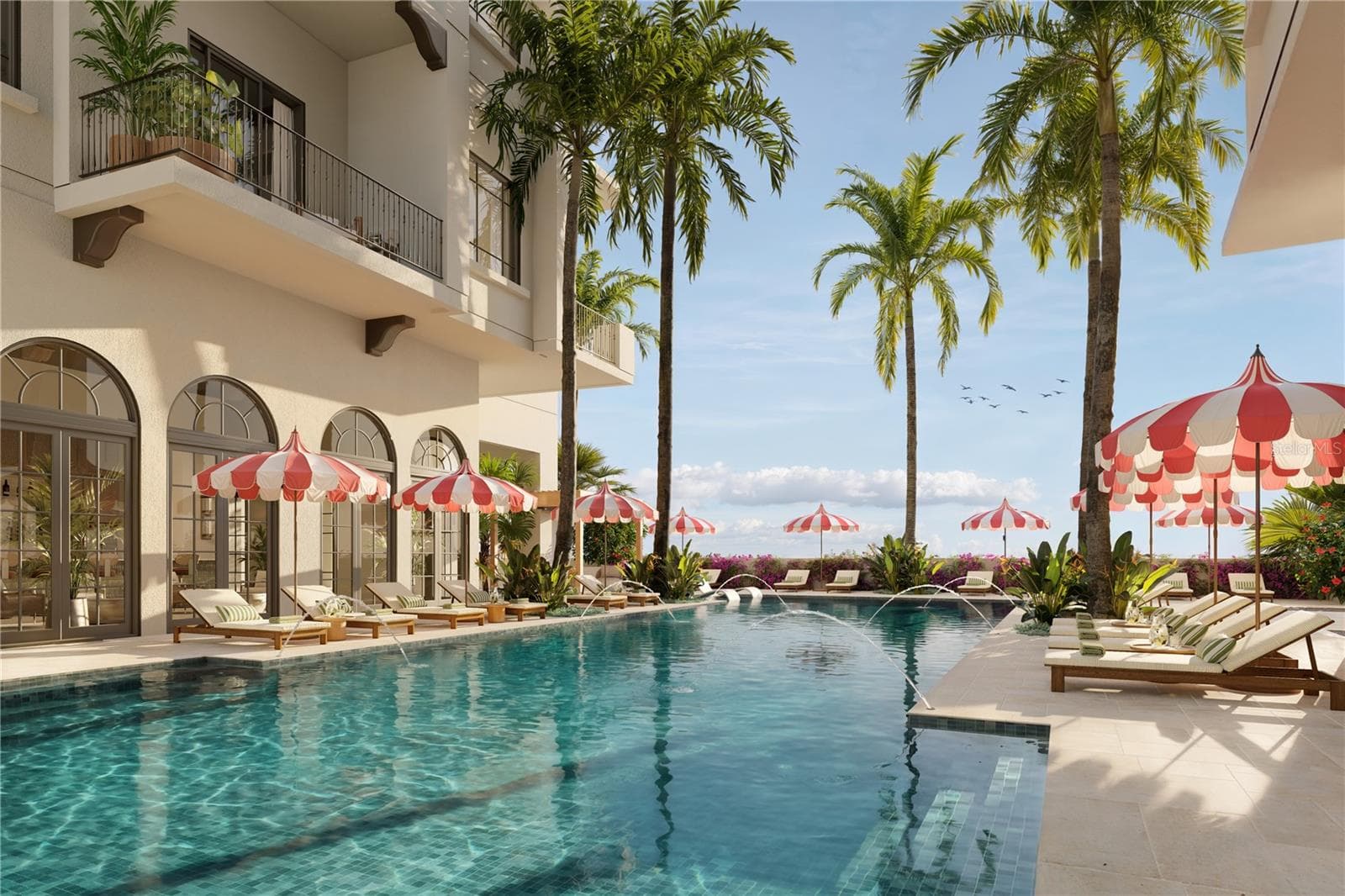 The 70-foot resort-style pool at Mira Mar is complemented by a lounging area with a spacious sun deck, hot tub, and dedicated towel service, creating a luxurious setting for relaxation and leisure. - 65 S PALM AVE #1205, SARASOTA