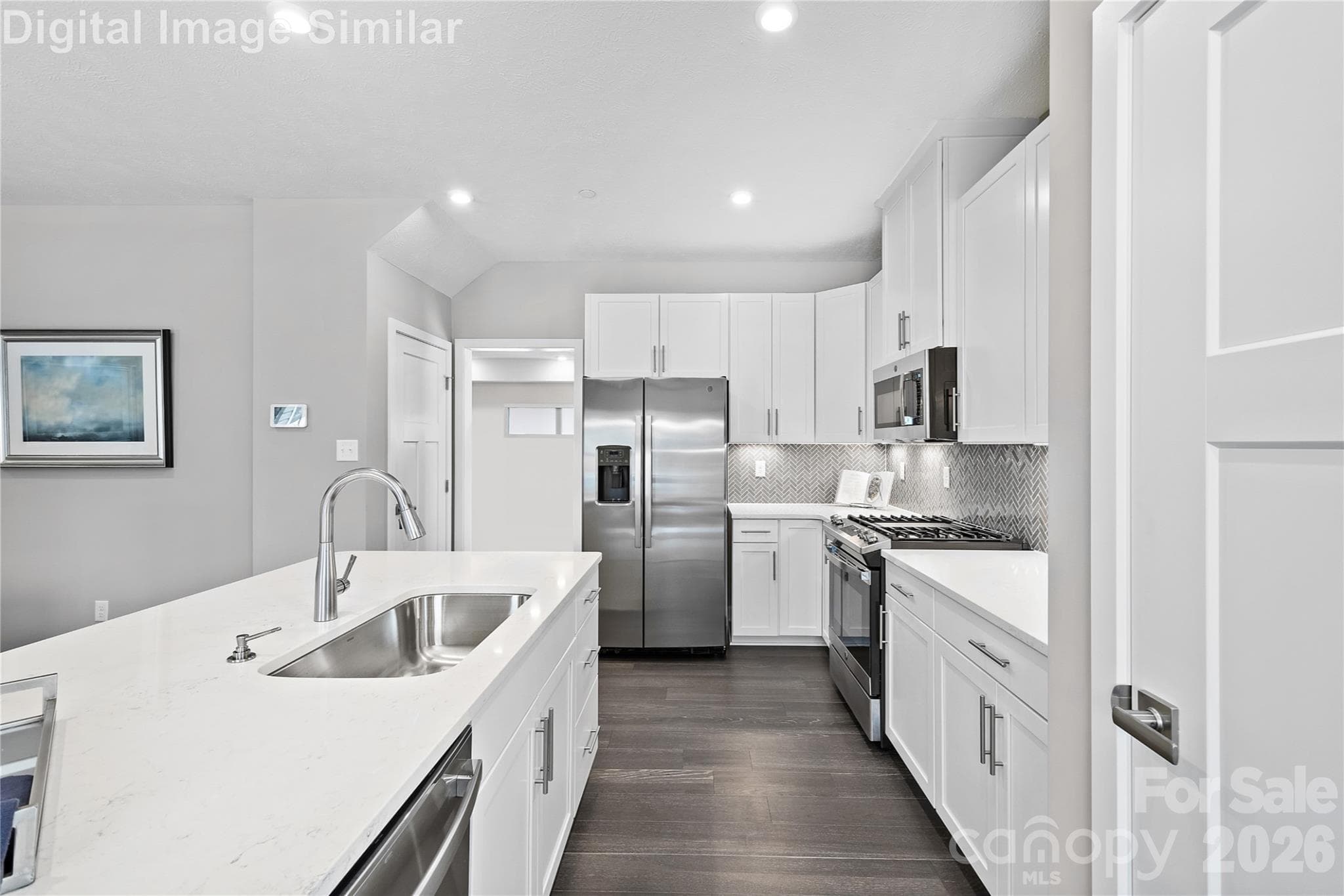 Elegant open-concept kitchen with upscale finishes, tall cabinetry, gleaming countertops and appliances - designed to impress and built to inspire - Charlotte