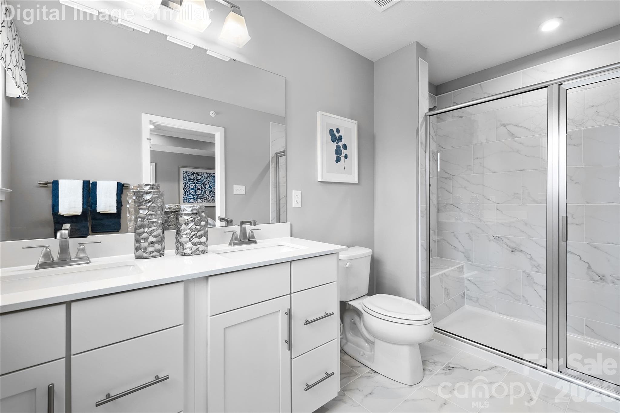 Private ensuite bath featuring optional sleek framed shower door, dual sinks with elegant fixtures, and built-in cabinetry for stylish, functional storage—your personal spa retreat. - Charlotte