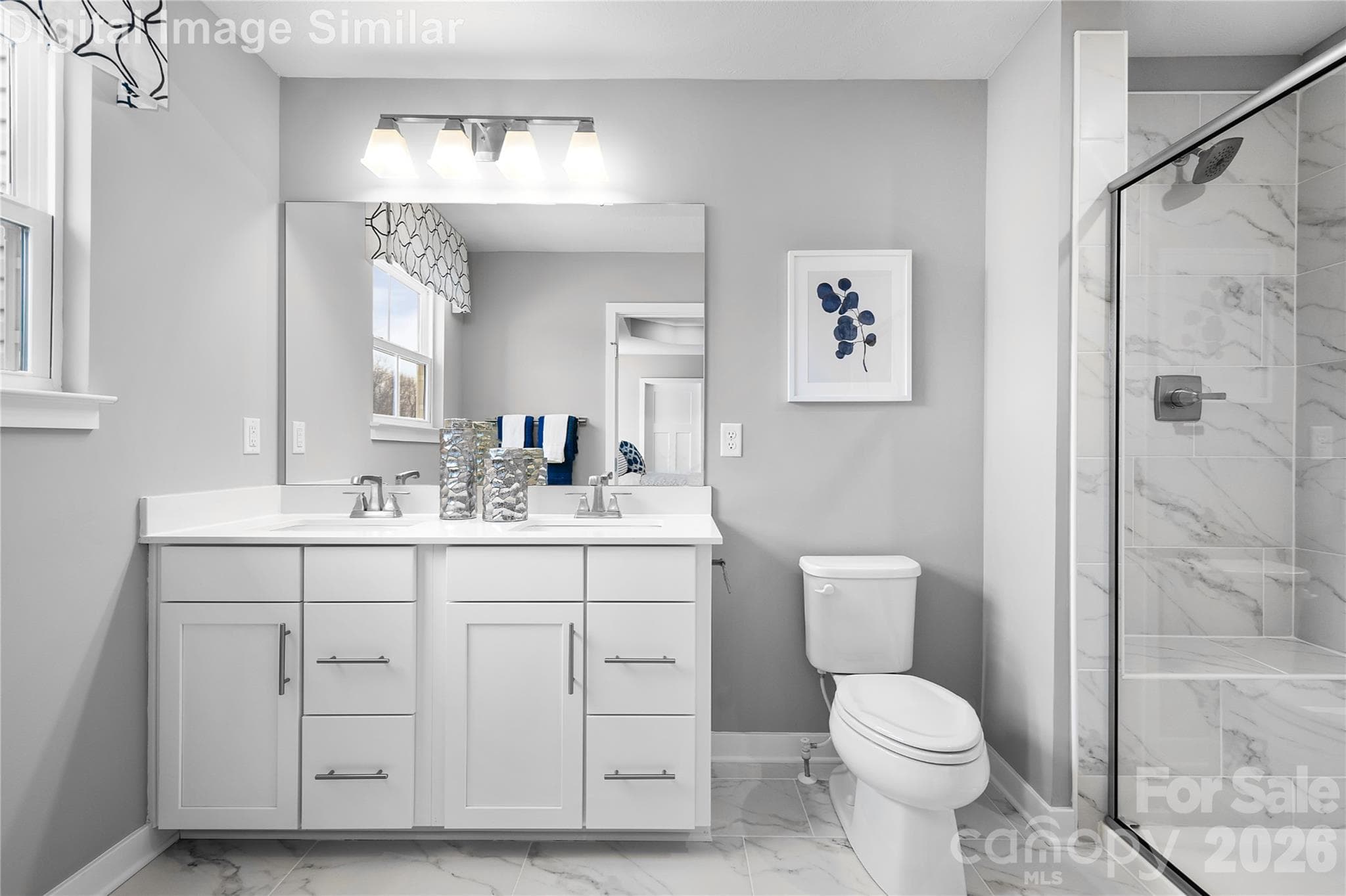 Love where you unwind—this sunlit primary bath features his-and-hers sinks, elegant finishes, and an optional Roman shower with a framed glass door for a spa-like touch. - Charlotte